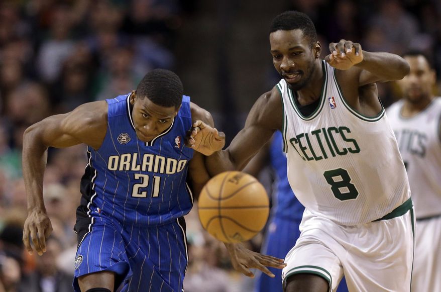 Orlando Magic forward Maurice Harkless (21) and Boston Celtics forward Jeff Green (8) chase a loose ball in the fourth quarter of an NBA basketball game on Sunday, Feb. 2, 2014, in Boston. The Celtics won 96-89. (AP Photo/Steven Senne)