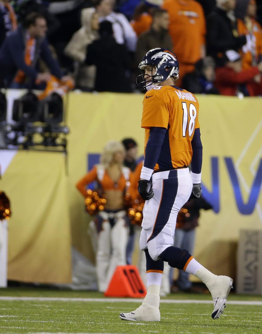 Denver Broncos' Peyton Manning walks to the sidelines after throwing an interception during the first half of the NFL Super Bowl XLVIII football game against the Seattle Seahawks Sunday, Feb. 2, 2014, in East Rutherford, N.J. (AP Photo/Matt Slocum)