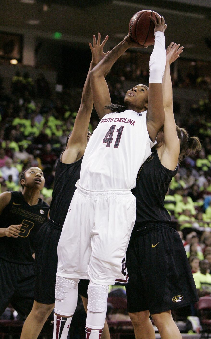 South Carolina's Alaina Coates (41) drives for the basket as Missouri tries to defend during the first half of their NCAA college basketball game, Sunday Feb. 2, 2014, in Columbia, SC. (AP Photo/Mary Ann Chastain)