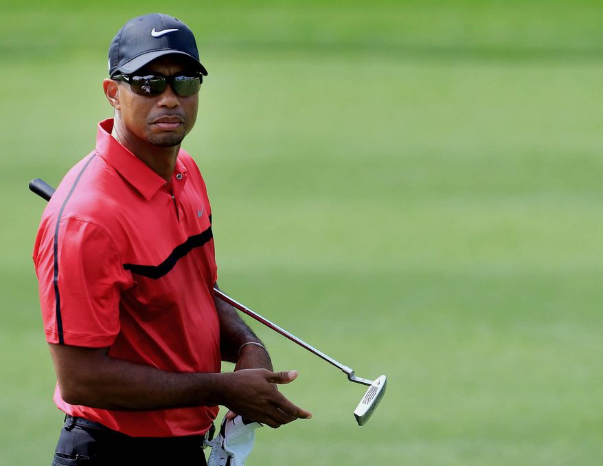 Tiger Woods of the U.S. walks on the fairway of the 12th hole during the final round of the Dubai Desert Classic golf tournament in Dubai, United Arab Emirates, Sunday, Feb. 2, 2014. (AP Photo)