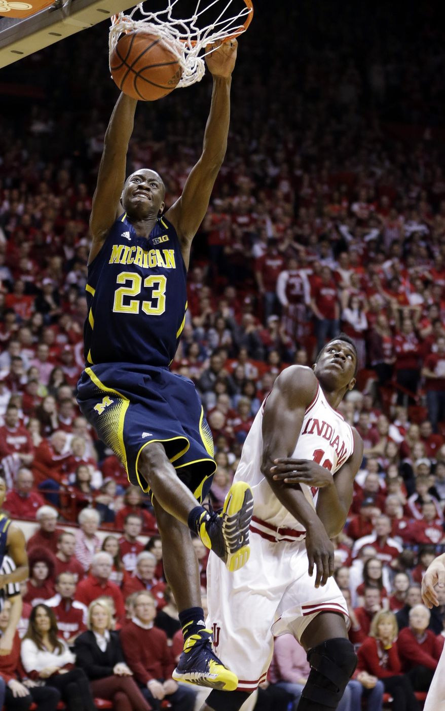 Michigan guard Caris LeVert (23) dunks over Indiana forward Hanner Mosquera-Perea in the first half of an NCAA college basketball game in Bloomington, Ind., Sunday, Feb. 2, 2014. (AP Photo/Michael Conroy)