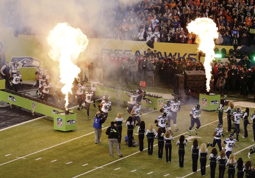 The Seattle Seahawks run on to the field for the NFL Super Bowl XLVIII football game against the Denver Broncos Sunday, Feb. 2, 2014, in East Rutherford, N.J. (AP Photo/Charlie Riedel)