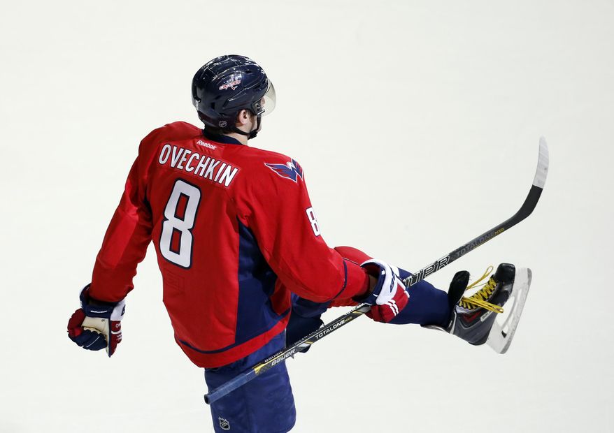 Washington Capitals right wing Alex Ovechkin (8), from Russia, celebrates his game-winning goal in the overtime period of an NHL hockey game against the Detroit Red Wings, Sunday, Feb. 2, 2014, in Washington. The Capitals won 6-5. (AP Photo/Alex Brandon)