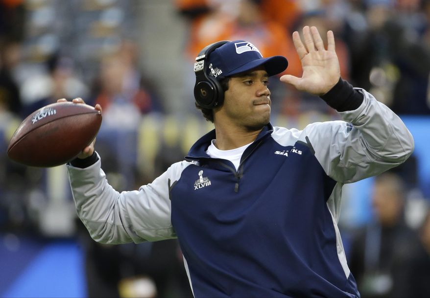 Seattle Seahawks quarterback Russell Wilson warms up before the NFL Super Bowl XLVIII football game against the Denver Broncos Sunday, Feb. 2, 2014, in East Rutherford, N.J. (AP Photo/Matt Slocum)