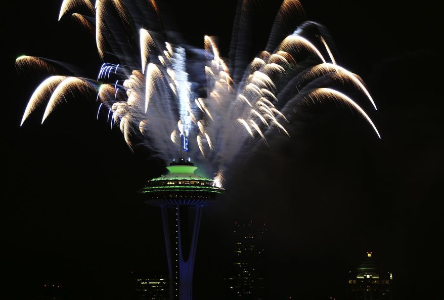 Celebratory fireworks are set off behind The Space Needle in Seattle, after the Seahawks won the Super Bowl for the first time in history on Sunday, Feb. 2, 2014. The Seahawks, in their second Super Bowl appearance ever, won 43-8 over the Denver Broncos at MetLife Stadium in New Jersey. (AP Photo/The Seattle Times, Lindsey Wasson)