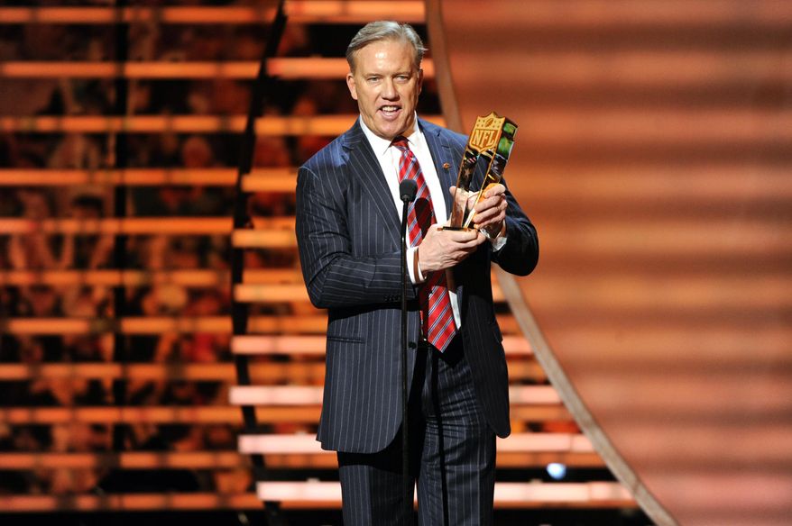 Former NFL quarterback John Elway accepts the award for AP Offensive Player of the Year on behalf of winner Peyton Manning of the Denver Broncos, at the third annual NFL Honors at Radio City Music Hall on Saturday, Feb. 1, 2014, in New York. (Photo by Evan Agostini/Invision for NFL/AP Images)