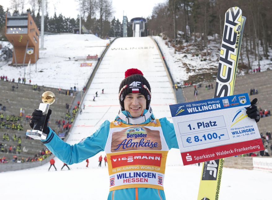 Winner Kamil Stoch of Poland celebrates during the FIS World Cup ski jumping in Willingen, Germany, Sunday, Feb. 2, 2014. (AP Photo/Jens Meyer)