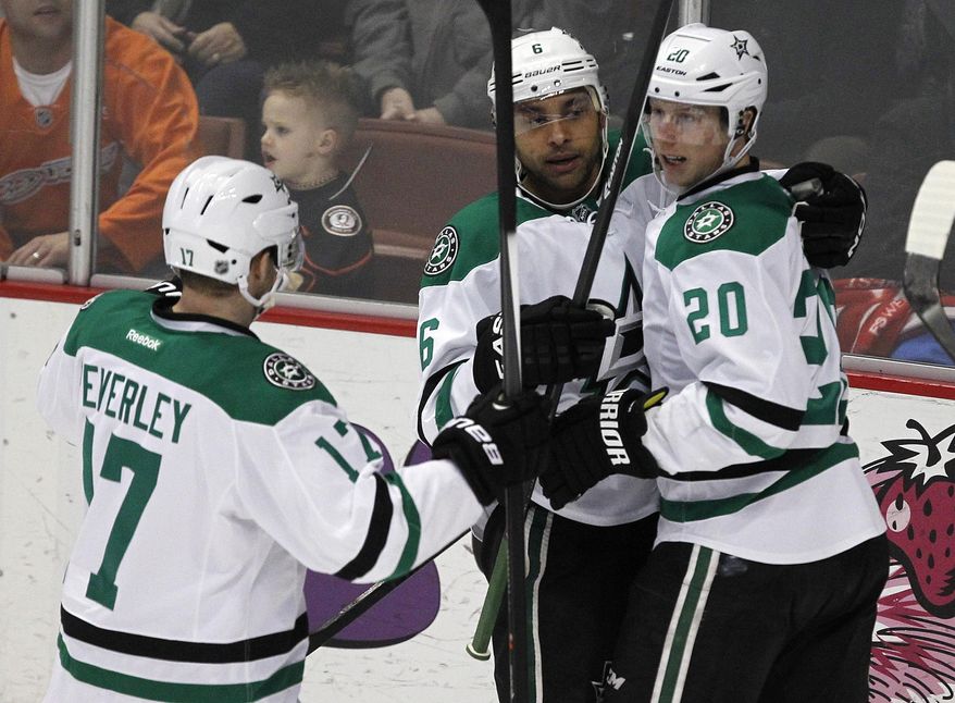 Dallas Stars' Rich Peverley (17) and Cody Eakin (20) congratulate Trevor Daley, left, who scored against the Anaheim Ducks in the second period of an NHL hockey game Saturday, Feb. 1, 2014, in Anaheim, Calif. (AP Photo/Alex Gallardo)