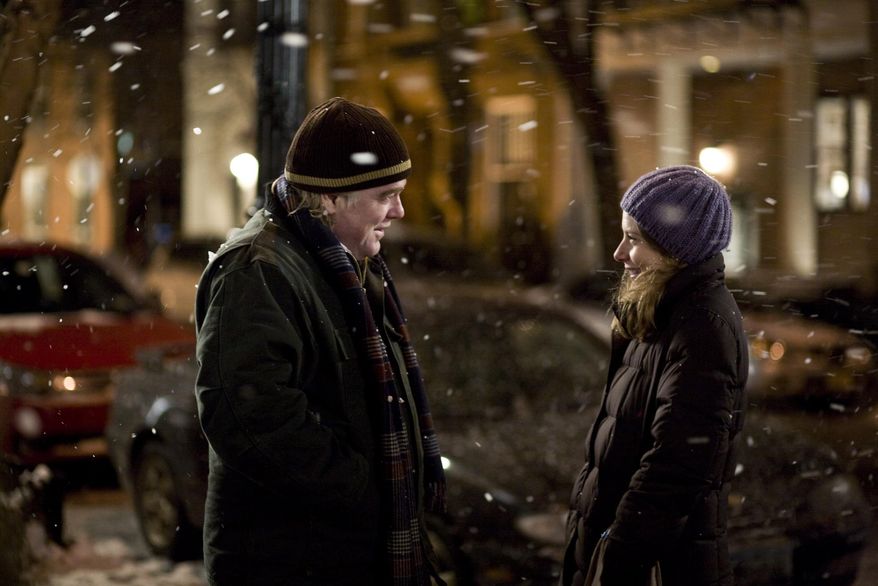 File-In this film publicity image released by Overture Films, Phillip Seymour Hoffman, left, and Amy Ryan are shown in a scene from, "Jack Goes Boating." In a medium (movies) that prizes glamor and flash, he offered the opposite: untidy, imperfect, shy, awkward and eminently real people. Despite his outsized talent, he was relentlessly humble. Bennett Miller, his longtime friend and “Capote” director, once called him “a shaman-like actor.” (AP Photo/Overture Films, K.C. Bailey, File)