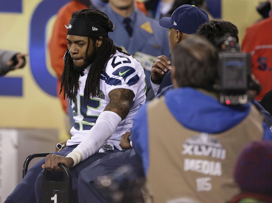 Seattle Seahawks cornerback Richard Sherman (25) leaves the field after being injured during the second half of the NFL Super Bowl XLVIII football game against the Denver Broncos Sunday, Feb. 2, 2014, in East Rutherford, N.J. (AP Photo/Gregory Bull)