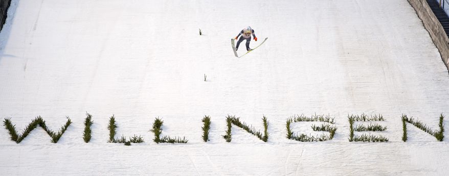 Winner Kamil Stoch of Poland soars through the air during the qualification at the FIS World Cup ski jumping in Willingen, Germany, Sunday, Feb. 2, 2014. (AP Photo/Jens Meyer)