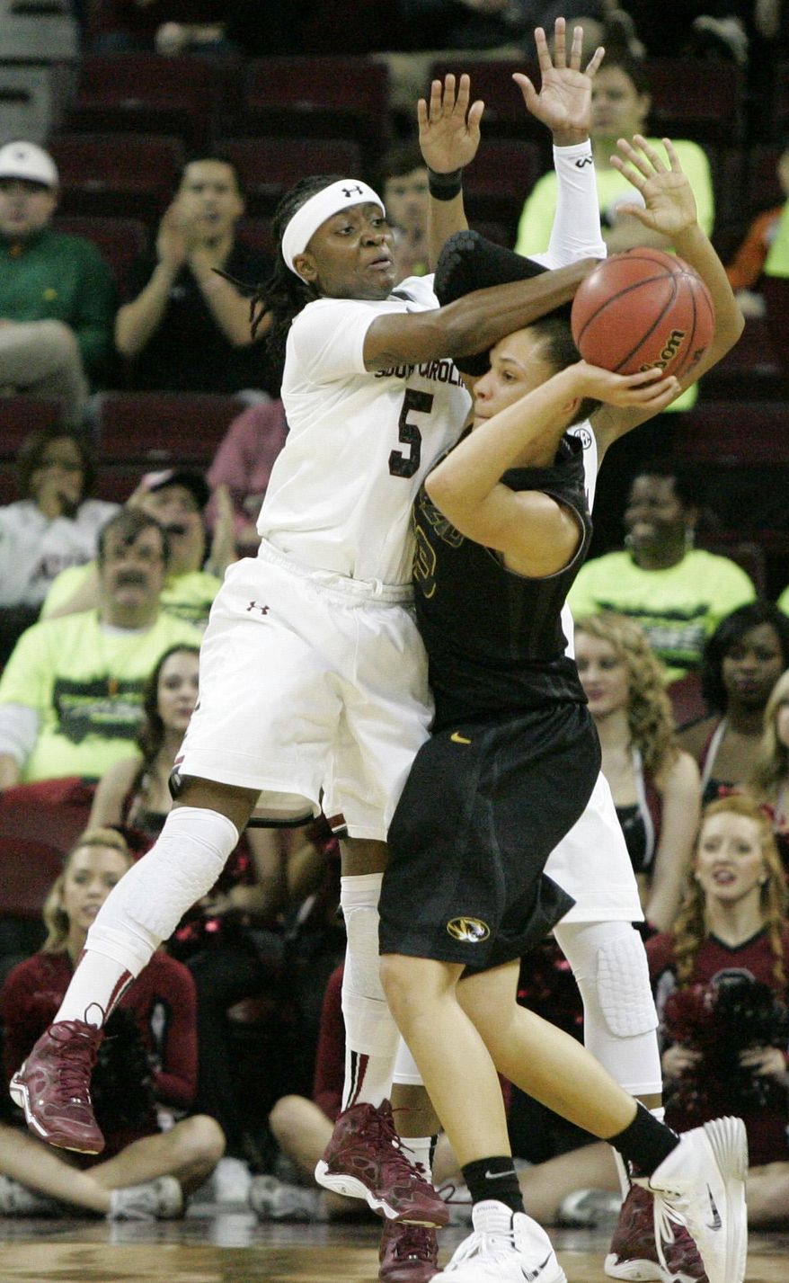 South Carolina's Khadijah Sessions (5) gets called for the foul as Missouri's Bri Kulas (13) tries to move the ball during the second half of their NCAA college basketball game, Sunday Feb. 2, 2014, in Columbia, SC. (AP Photo/Mary Ann Chastain)