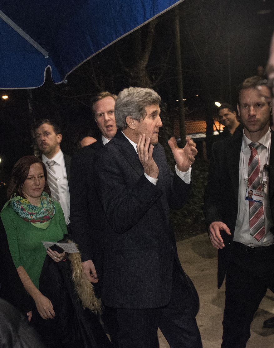 In thjis picture taken Saturday Feb. 1, 2014, US Secretary of State John Kerry reacts as a man yells at him while walking to Augustiner-Keller restaurant in Munich, Germany. Kerry attends the Security Conference in Munich. (AP Photo/Brendan Smialowski,Pool)