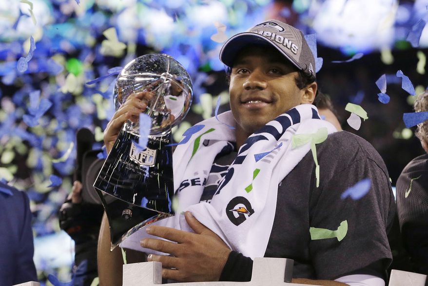 Seattle Seahawks' quarterback Russell Wilson holds the Lombardi Trophy after the NFL Super Bowl XLVIII football game Sunday, Feb. 2, 2014, in East Rutherford, N.J. The Seahawks won 43-8. (AP Photo/Julio Cortez)