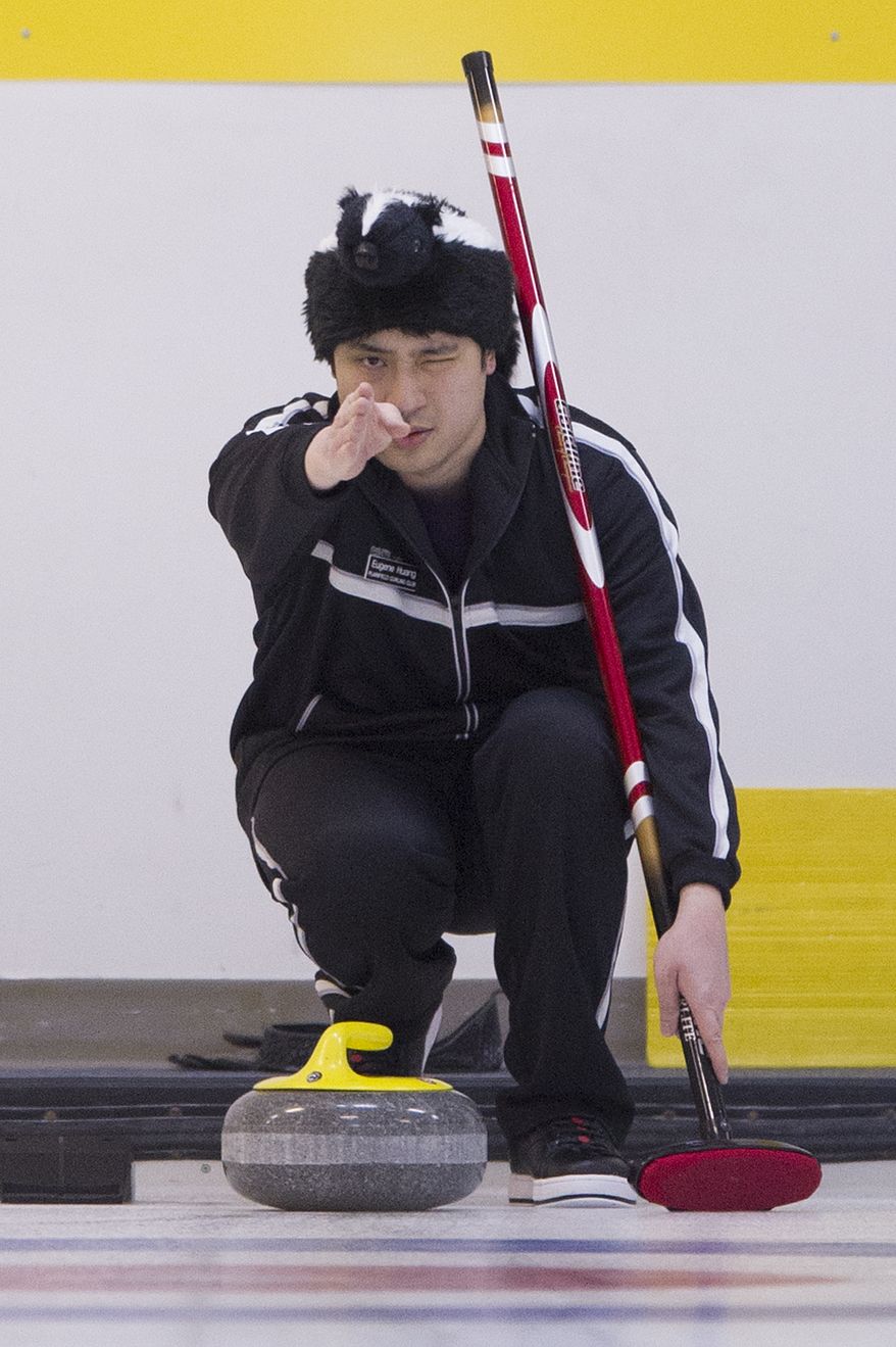 Eugene Huang from the Plainfield Curling Club, N.J., lines up his delivery during the curling competition at the Potomac Curling Club in Laurel, Md.
(Preston Keres/Special to The Washington Times)