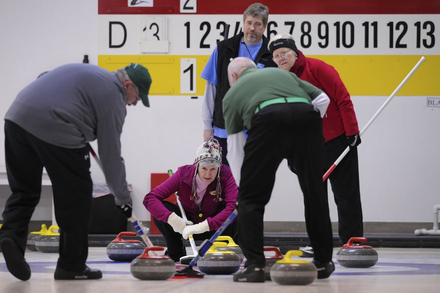 Jeanne Kenkel (center), from the Chesapeake Curling Club, Md., provides the the sweepers direction during the curling competition at the Potomac Curling Club in Laurel, Md.
(Preston Keres/Special to The Washington Times)