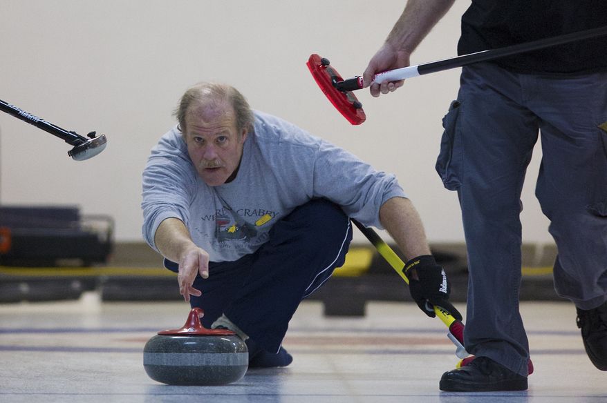 George Shirk, from the Potomac Curling Club, Md., delivers the stone down the sheet during the curling competition at the Potomac Curling Club in Laurel, Md.
(Preston Keres/Special to The Washington Times)