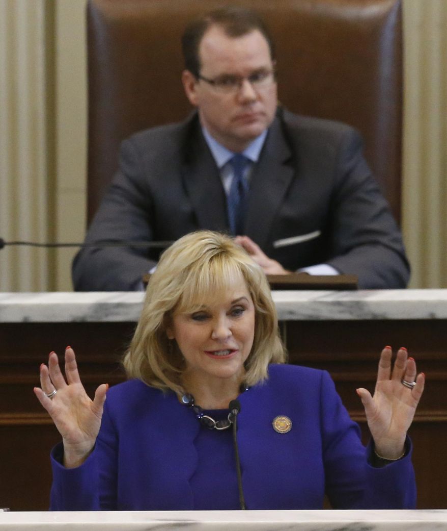 Oklahoma Governor Mary Fallin gestures as she gives her State of the State address in Oklahoma City, Monday, Feb. 3, 2014. Behind her is Lt. Governor Todd Lamb. (AP Photo/Sue Ogrocki)