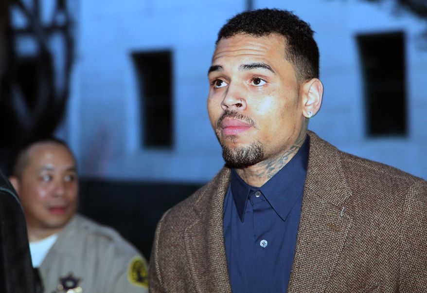 R&B singer Chris Brown arrives at a Los Angeles Superior Court for a probation review hearing on Monday, Feb. 3, 2014, in Los Angeles. The judge rejected a prosecutor's request during the hearing to have Brown sent to jail over the misdemeanor assault case filed last year in Washington, D.C. (AP Photo/Nick Ut)