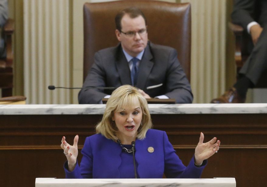 Oklahoma Governor Mary Fallin gestures as she gives her State of the State address in Oklahoma City, Monday, Feb. 3, 2014. Behind her is Lt. Governor Todd Lamb. (AP Photo/Sue Ogrocki)