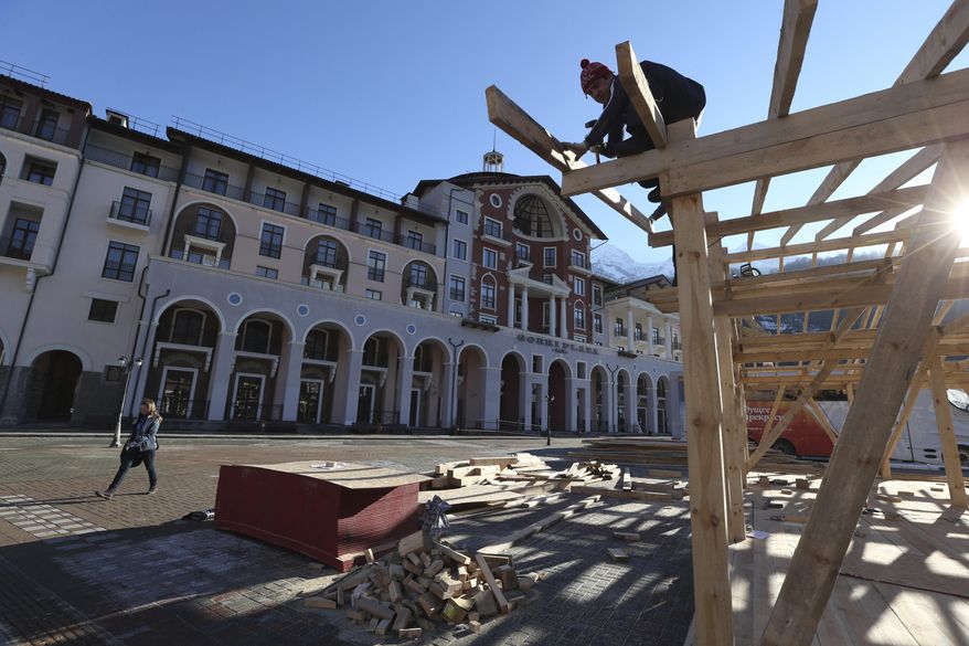 Construction work continues apace outside the Gorki Plaza East hotel in Krasnaya Polyana, Russia Sunday, Feb. 2, 2014. The IOC is urging Russian Olympic organizers to move quickly to resolve the issue of accommodations that are not ready for accredited media personnel in the mountains outside Sochi. According to the 2014 Sochi Winter Olympic organizing committee, only six of the nine media hotels in the mountain area are fully operational. (AP Photo/Luca Bruno)