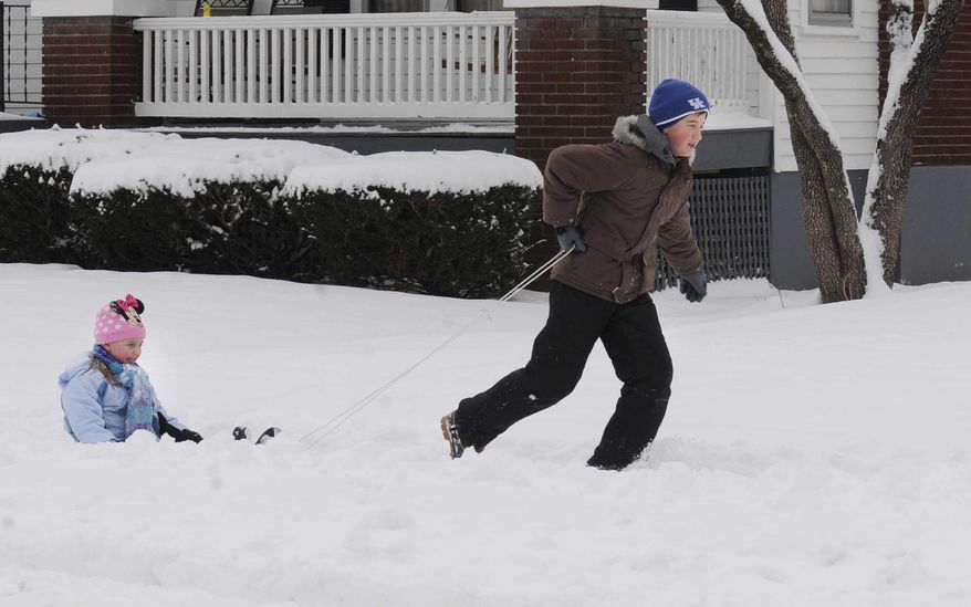 Bryan Walton pulls his sister, Camden Walton, on a sled near their home Monday, Feb. 3, 2014 in Maysville, Ky. Nearly 7 inches of snow fell overnight in the area. (AP Photo, The Ledger Independent, Terry Prather)