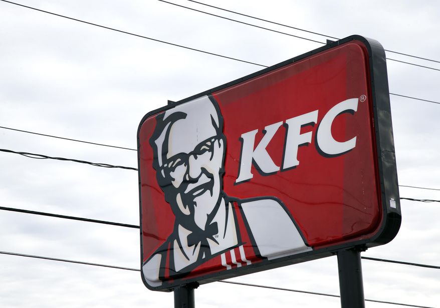 In this Friday, Jan. 31, 2014, photo, a KFC sign hangs in Saugus, Mass. Fast-food conglomerate Yum! Brands, Inc., headquartered in Louisville, Ky., will report its fourth-quarter and annual earnings on Monday after markets close. (AP Photo/Elise Amendola)