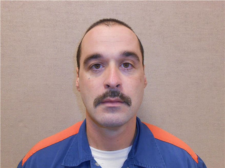 ** FILE ** This Feb. 11, 2013, photo provided by the Michigan Department of Corrections shows Michael David Elliot. Elliot, who is serving life behind bars for murder in four 1993 deaths in Michigan, has escaped from prison and may have abducted a woman before she got away in Indiana, according to officials. (AP Photo/Michigan Department of Corrections)