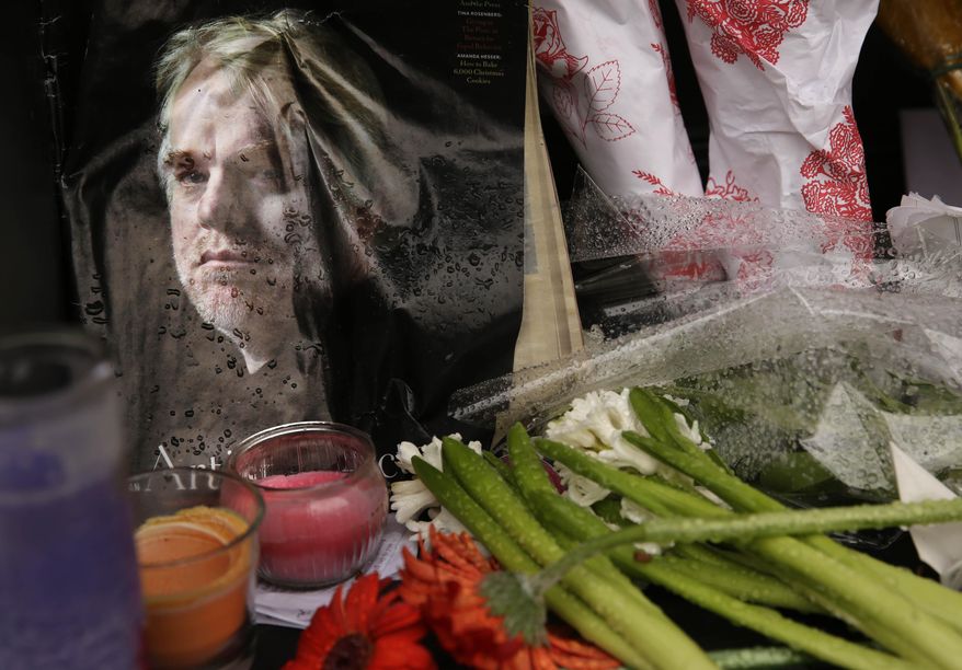A makeshift memorial is seen, Monday, Feb. 3, 2014, outside the building where the body of actor Philip Seymour Hoffman was found in New York. Hoffman, 46, was found dead Sunday in his apartment. (AP Photo/Seth Wenig)
