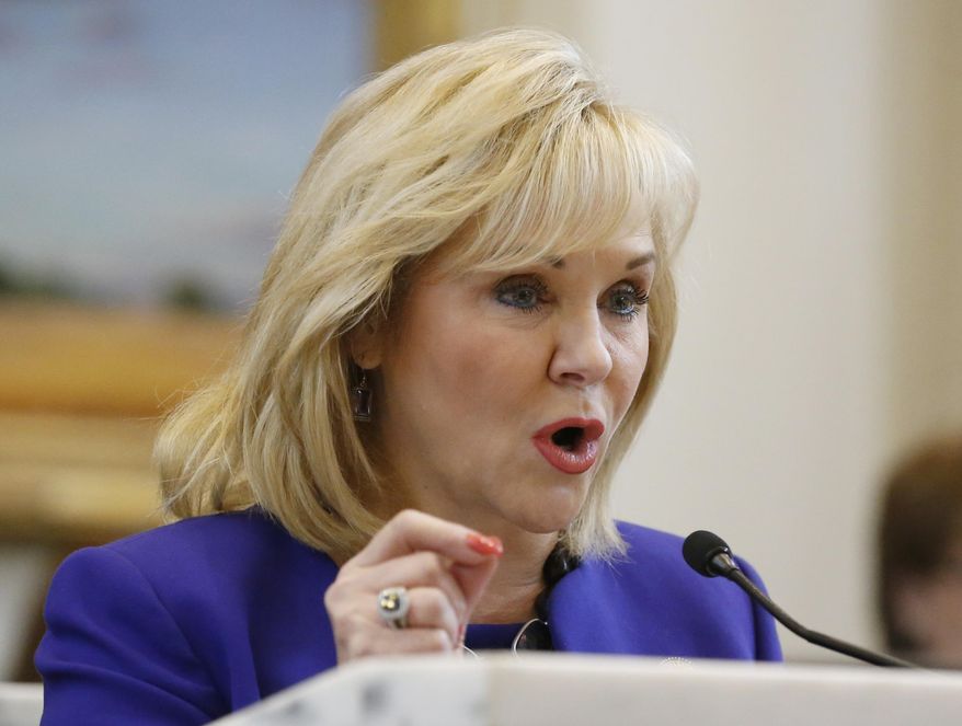 Oklahoma Governor Mary Fallin gestures as she speaks during her fourth State of the State address in Oklahoma City, Monday, Feb. 3, 2014. Fallin renewed her call for a cut in the state's income tax rate and asked legislators to approve a bond issue to help repair the state Capitol. (AP Photo/Sue Ogrocki)