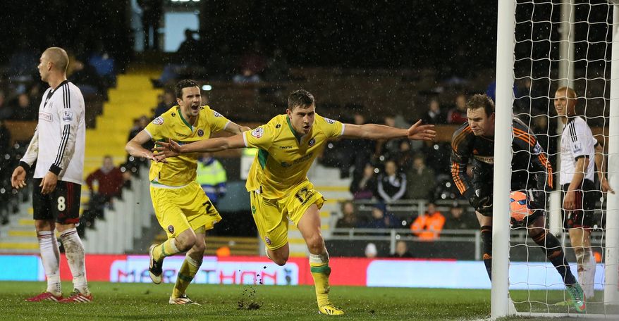 Sheffield United's Shaun Miller, N012, celebrates after scoring the only goal of the game against Fulham during their 4th round replay English FA Cup soccer match between Fulham and Sheffield United at Craven Cottage stadium in London, Tuesday, Feb. 4, 2014. Sheffield won 1-0 after extra time.(AP Photo/Alastair Grant)