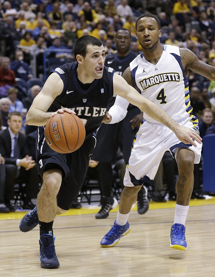 Butler's Alex Barlow, left, drives against Marquette's Todd Mayo (4) during the second half of an NCAA college basketball game, Tuesday, Feb. 4, 2014, in Milwaukee. (AP Photo/Jeffrey Phelps)