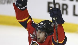 Florida Panthers&#39; Scottie Upshall (19) celebrates after Tom Gilbert scored a goal against the Toronto Maple Leafs during the second period of an NHL hockey game in Sunrise, Fla., Tuesday,  Feb. 4, 2014. (AP Photo/J Pat Carter)