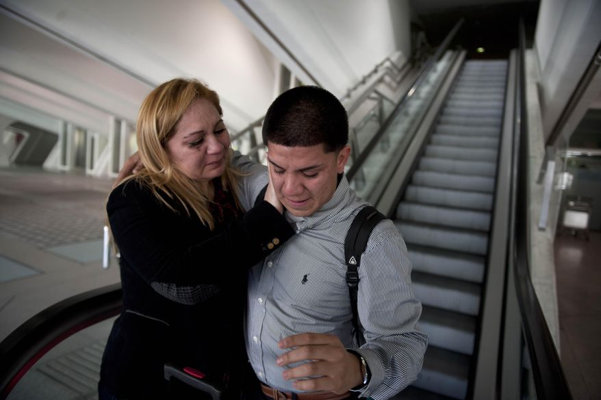 ADVANCE FOR USE SATURDAY, FEB. 8, 2014 AND THEREAFTER - In this Wednesday, Dec. 25, 2013 photo, Melba Soza comforts her son Jose Antonio, as he arrives at the Bilbao, Spain, airport from the United States. "I was afraid you would have lost the love for your mother," she told him. "I was afraid you’d look at me like a stranger," he said. (AP Photo/Alvaro Barrientos)