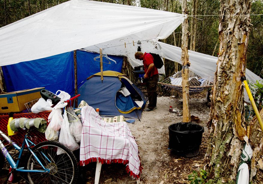 In this Jan. 14, 2014 photo, Lee Dugan, a homeless registered sex offender who had been living in the woods, prepares to head out for a meal at a local soup kitchen in Fort Myers, Fla. Dugan says he was physically dropped off at the site by a Lee County sheriff’s detective. Several sex offenders have registered the site as their address. (AP Photo/The News-Press, Andrew West ) MAGS OUT; NAPLES OUT; NO SALES