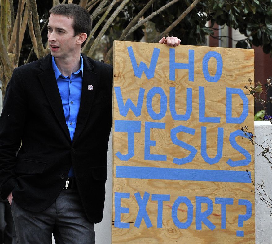 Ross Reddick, a Presbyterian minister from Sylacauga, Ala., holds a sign during a rally concerning predatory lending legislation Tuesday, Feb. 4, 2014, in Montgomery, Ala. Two Birmingham-area legislators are again trying to cap the interest rates on payday and title loans, but they admit it will be hard to enact in an election year. (AP PHOTO/AL.com, Julie Bennett) albinap(AP Photo/AL.com, ) MAGS OUT (REV-SHARE) MBI