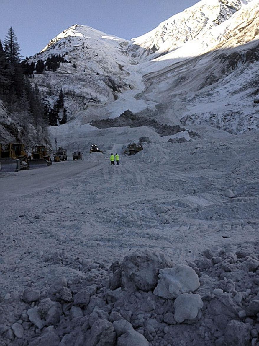This photo provided by the Alaska Department of Transportation shows snow from an avalanche covers a road outside of Valdez, Alaska on Tuesday, Feb. 4, 2014. Alaska highway officials say they expect to reopen an avalanche-choked highway by Wednesday afternoon, nearly two weeks after walls of snow cut off the only road into Valdez. (AP Photo/Alaska Dept. of Transportation)
