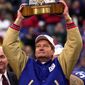 New York Giants head coach Jim Fassel holds up theNFC  Championship trophy after defeating the Minnesota Vikings 41-0 Sunday, Jan. 14, 2001, in East Rutherford, N.J. (AP Photo/Bill Kostroun)