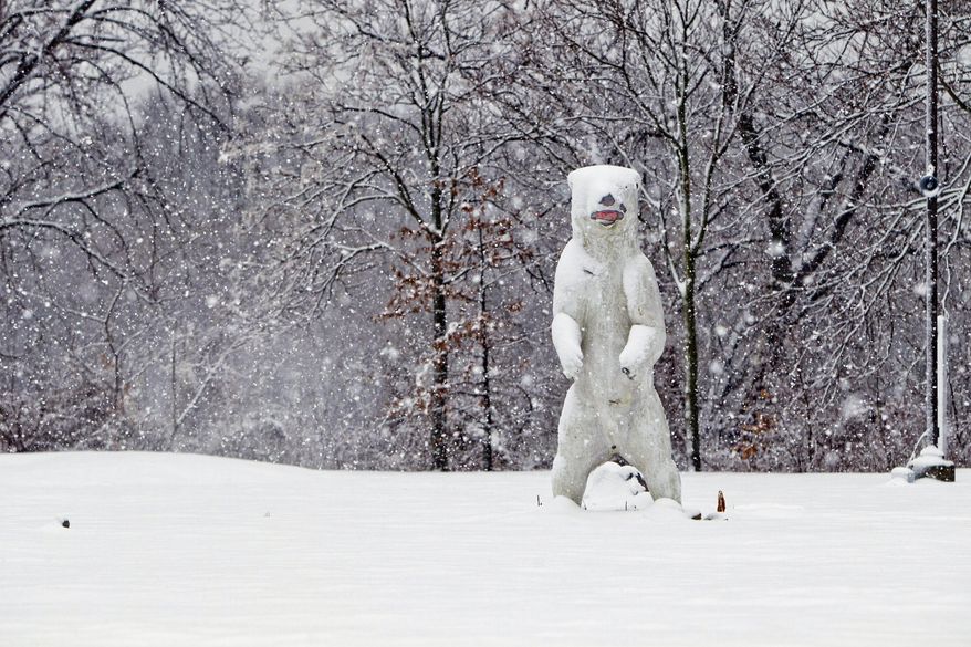 Snow covers a life sized polar bear statue in Cherry Hill, N.J., Monday, Feb. 3, 2014. New Jersey Gov. Chris Christie has issued a state of emergency as a major winter storm hit New Jersey with snow on Monday. (AP Photo/The Philadelphia Inquirer, David M Warren) PHIX OUT; TV OUT; MAGS OUT; NEWARK OUT