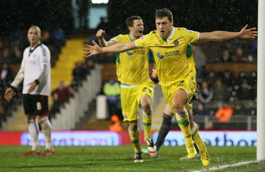 Sheffield United's Shaun Miller, N012, celebrates after scoring the only goal of the game against Fulham during their 4th round replay English FA Cup soccer match between Fulham and Sheffield United at Craven Cottage stadium in London, Tuesday, Feb. 4, 2014. Sheffield won 1-0 after extra time.(AP Photo/Alastair Grant)