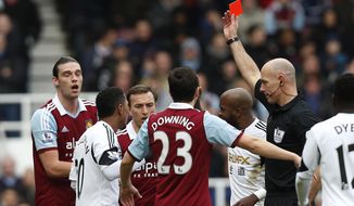 West Ham United&#x27;s Andy Carroll, left, is shown a red card by referee Howard Webb for his challenge on Swansea City&#x27;s Chico Flores during their English Premier League soccer match at Upton Park, London, Saturday, Feb. 1, 2014. (AP Photo/Sang Tan)