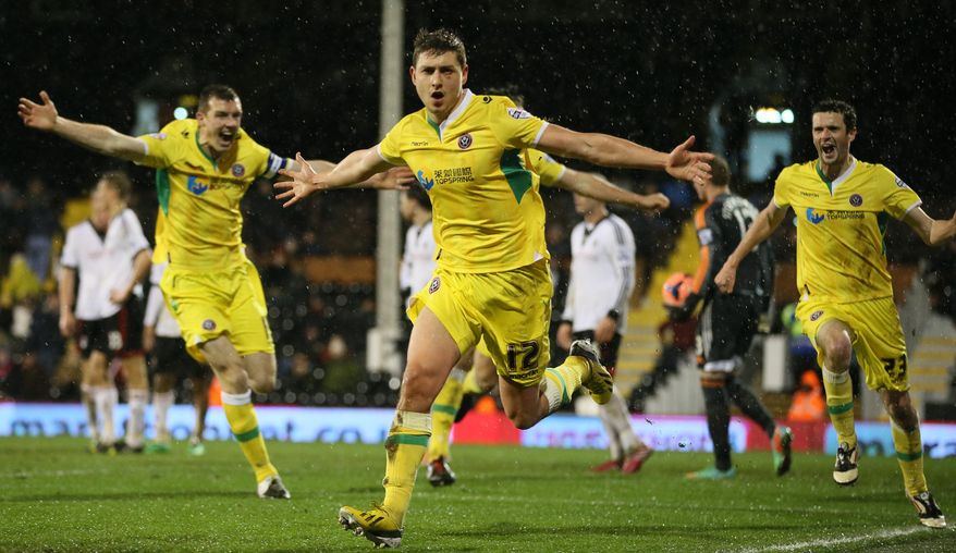 Sheffield United's Shaun Miller, N012, celebrates after scoring the only goal of the game against Fulham during their 4th round replay English FA Cup soccer match between Fulham and Sheffield United at Craven Cottage stadium in London, Tuesday, Feb. 4, 2014. Sheffield won 1-0 after extra time.(AP Photo/Alastair Grant)