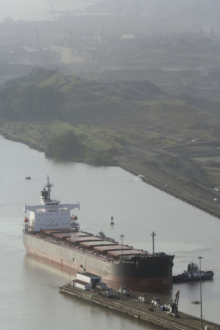 In this file photo, a ship sails into the Pedro Miguel locks on the Panama Canal near an area under construction as a part of its expansion project in Panama City, Tuesday, Feb. 4, 2014.  (AP Photo/Arnulfo Franco)