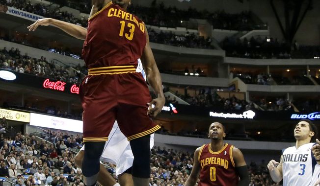 Cleveland Cavaliers&#x27; Tristan Thompson (13) dunks after getting past Dallas Mavericks&#x27; Brandan Wright, rear, as C.J. Miles (0) and Shane Larkin (3) watch in the first half of an NBA basketball game, Monday, Feb. 3, 2014, in Dallas. (AP Photo/Tony Gutierrez)