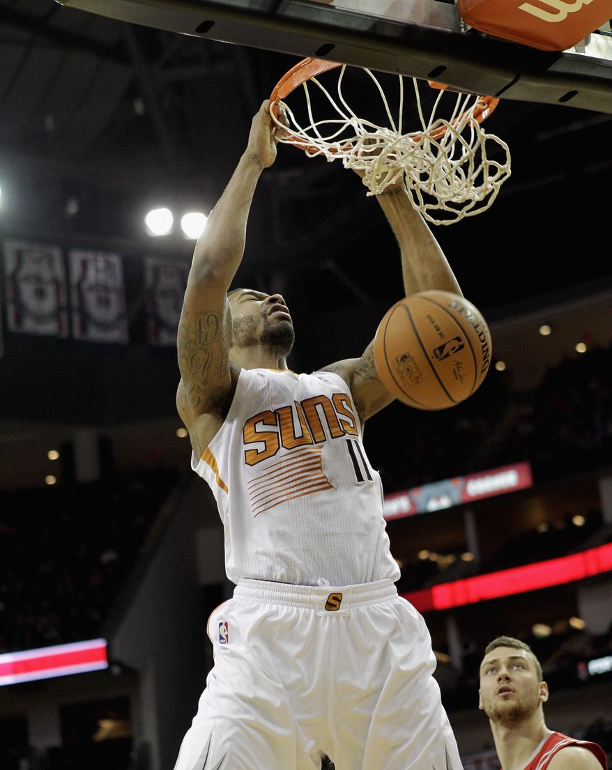 Phoenix Suns power forward Markieff Morris dunks against the Houston Rockets in the first half of an NBA basketball game on Wednesday, Feb. 5, 2014, in Houston. (AP Photo/Bob Levey)