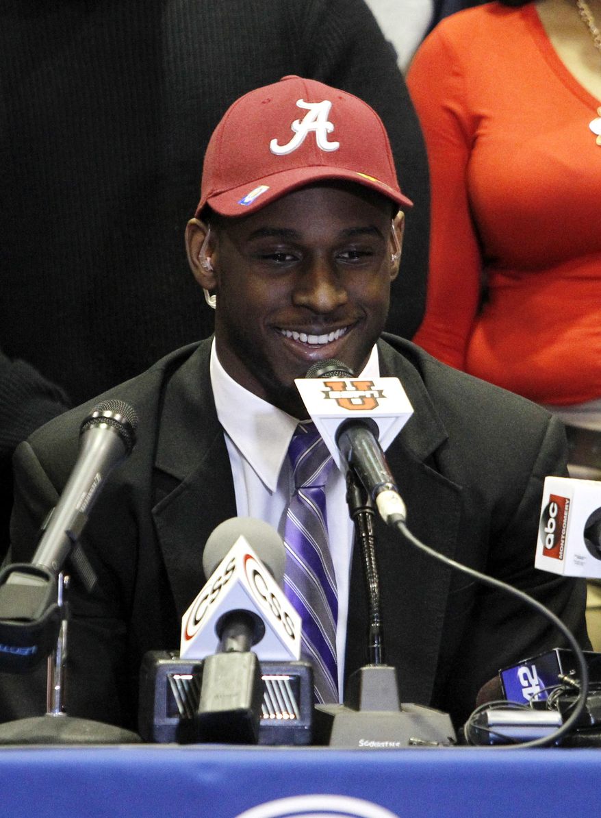 Rashaan Evans smiles after the Auburn High School football player announced that he will attend Alabama during a national signing day ceremony on Wednesday, Feb. 5, 2014, in Auburn, Ala. (AP Photo/Butch Dill)