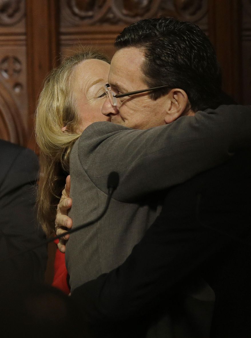 Connecticut Gov. Dannel P. Malloy receives a hug and a kiss from his wife Cathy after delivering his 2014 State of the State address in front of a joint session of the legislature in the House Chambers at the Capitol in Hartford, Conn., Thursday, Feb. 6, 2014. (AP Photo/Stephan Savoia)
