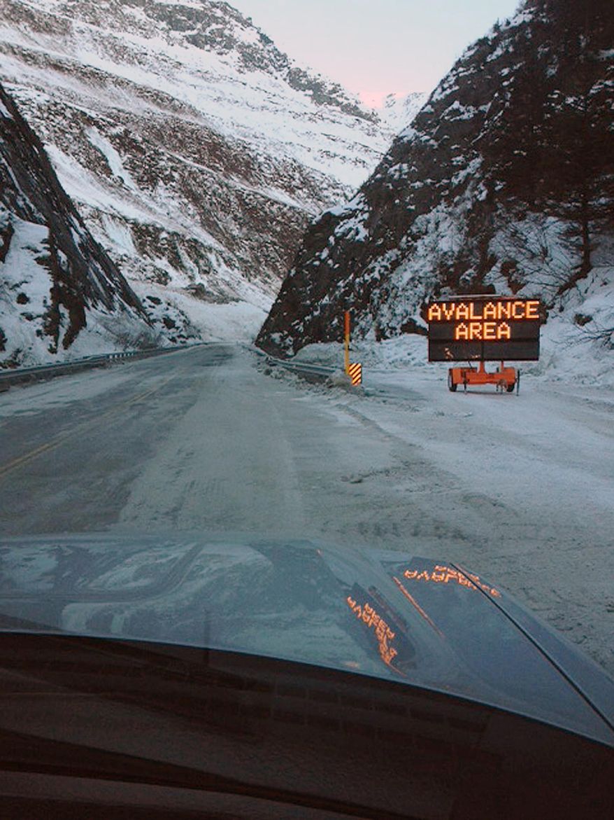 This Feb. 5, 2014 photo released by the Alaska Department of Transportation & Public Facilities shows Richardson Highway at Keystone Canyon, Valdez, Alaska. On Wednesday Feb. 5, 2014 two weeks after cascades of snow prevented vehicles from getting into the only road to Valdez has reopened. Crews finished clearing away the remaining avalanche debris, and there was no damage to Richardson Highway. (AP Photo/Alaska Department of Transportation & Public Facilities)