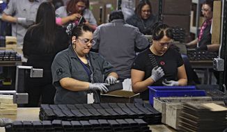 FILE - In this Feb. 28, 2013 file photo, workers assemble 30-round capacity ammunition magazines for high-velocity rifles, inside the Magpul Industries plant in Erie, Colo. Magpul, one of the country&#39;s largest producers of ammunition magazines for guns, is leaving Colorado and moving operations to Wyoming because of Colorado laws that include restrictions on how many cartridges a magazine can hold. The Wyoming State Loan and Investment Board is considering a $13 million incentive package to help Magpul make the move. (AP Photo/Brennan Linsley, File)
