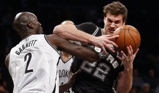 San Antonio Spurs&#39; Tiago Splitter (22), of Brazil, is fouled by Brooklyn Nets&#39; Kevin Garnett (2) during the first half of an NBA basketball game on Thursday, Feb. 6, 2014, in New York. (AP Photo/Jason DeCrow)